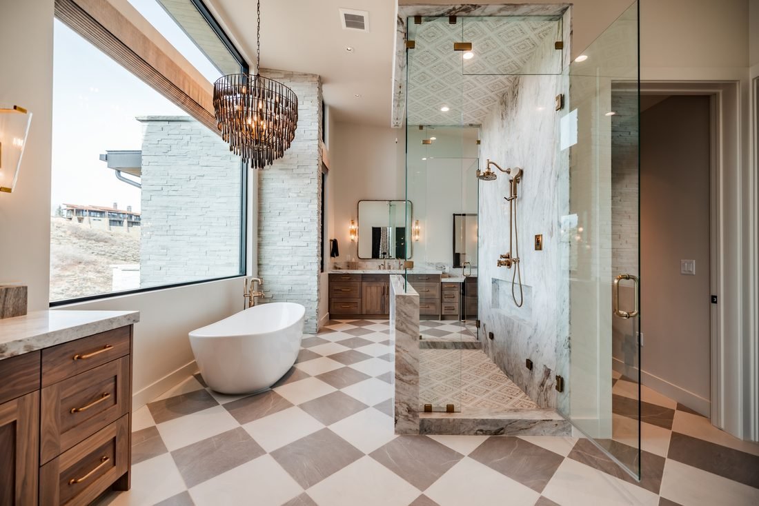Bathroom with a checkered stone floor and a chandelier