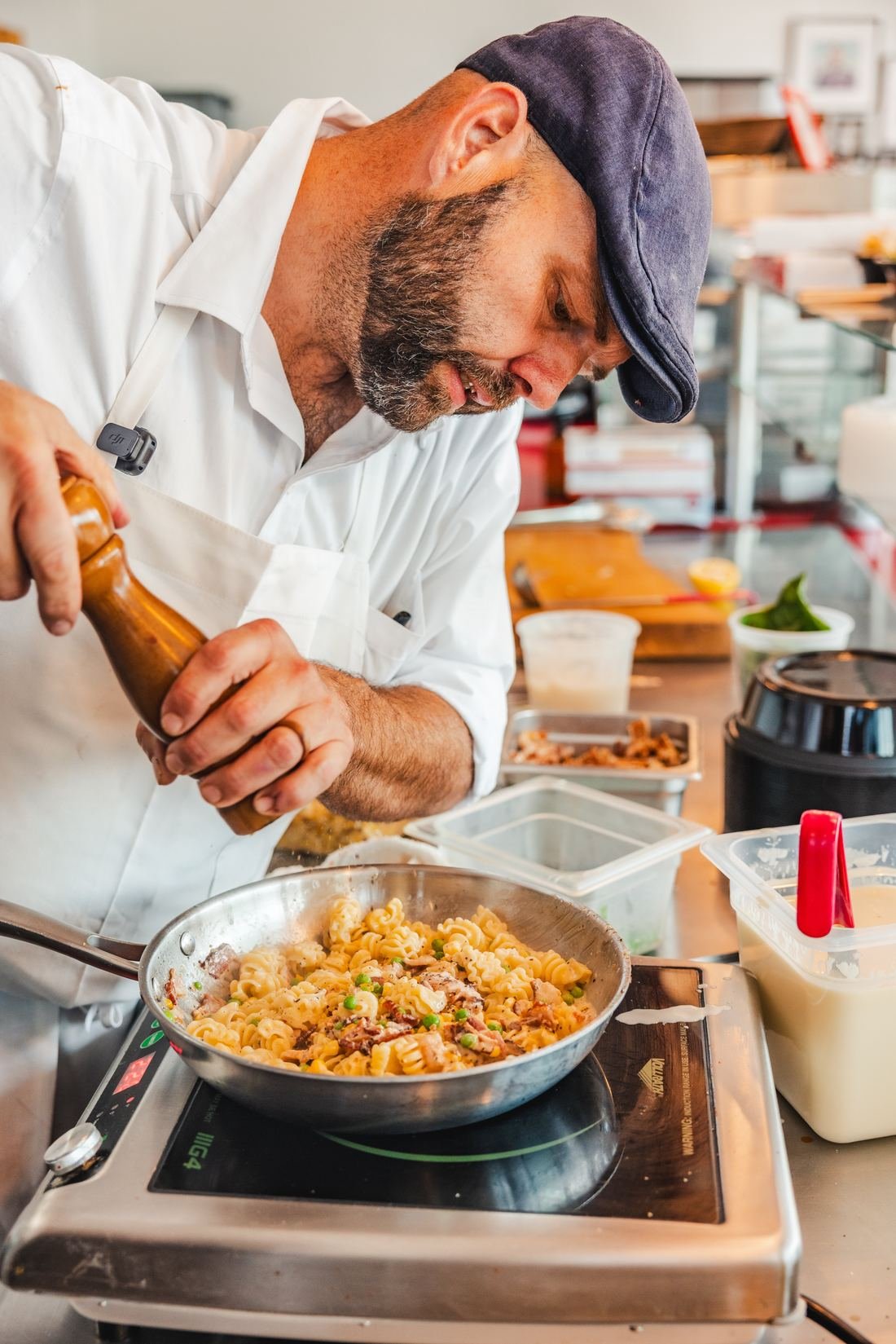 Chef finishing a pan of pasta