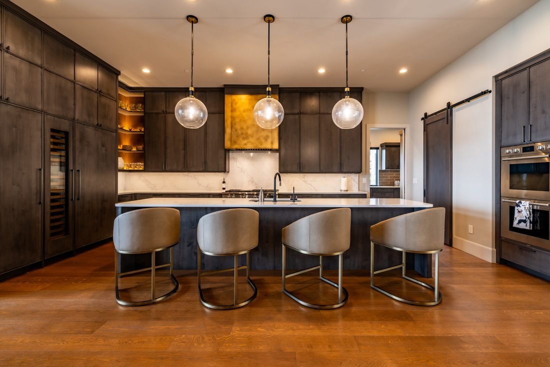 Kitchen island under three glass pendants