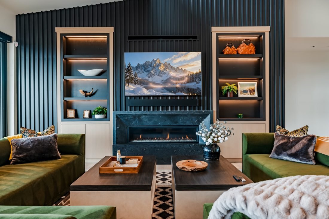 Living room with green sofas and a linear fireplace