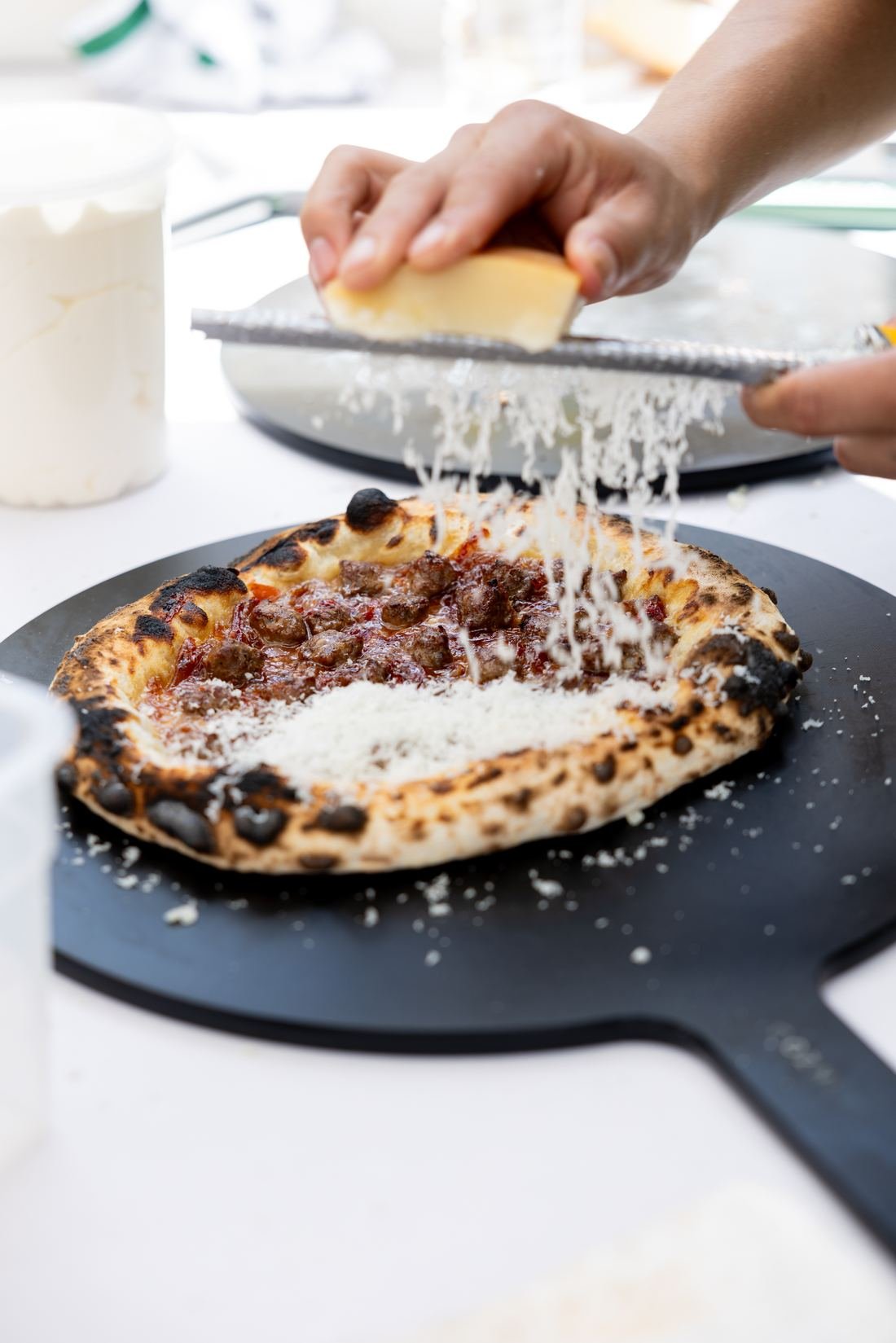 Cheese grated over a wood fired pizza