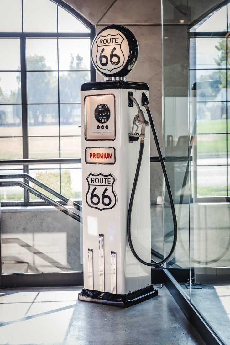 Restored Route 66 fuel pump in a showroom stairwell