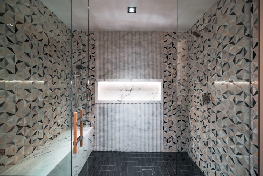 Walk in shower in patterned marble tile