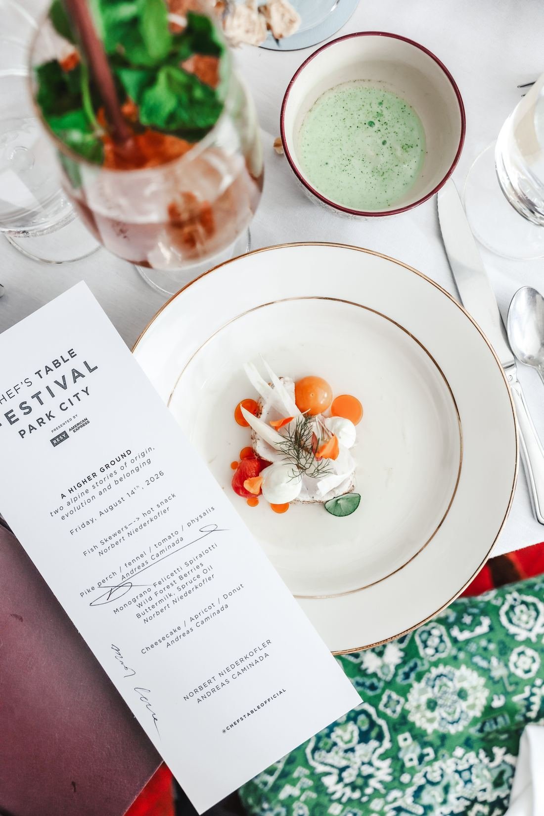 Tasting menu card beside a plated course