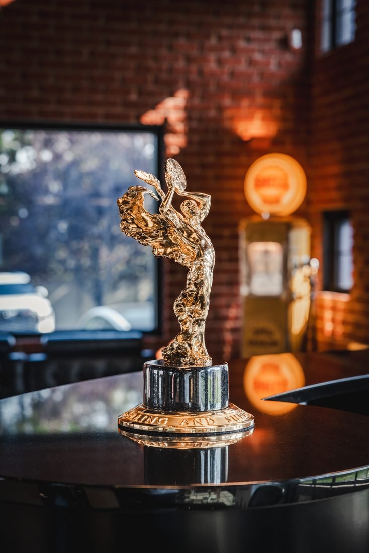 Gold dealership award lit against warm bokeh
